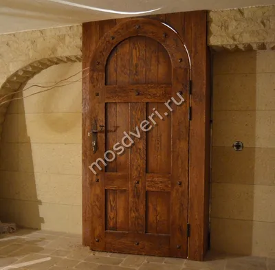 Входная арочная дверь в портале из массива