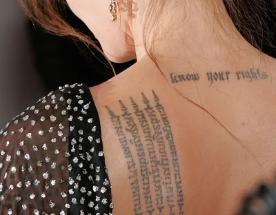 Which Celebrity Has These Tattoos on Her Back? | Celebrity tattoos, Text  tattoo, Angelina jolie back tattoo