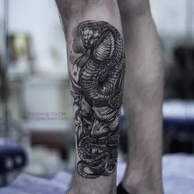 фото черно-белой татуировки на ноге у мужчины маска Хання и змея / Тату  салон «Дом Элит Тату»