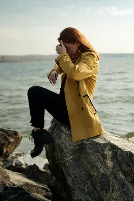 Девушка сидит на берегу моря - обои на телефон