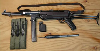 A German submachine gun MP 40, stamped \"ayf\" and \"1943\" (Waffenfabrik  B.Geipel G.m.b.H. Erma, Erfurt), calibre 9 x 19, number 8697. Original  leather sling, brown bakelite lower frame part, black bakelite grip