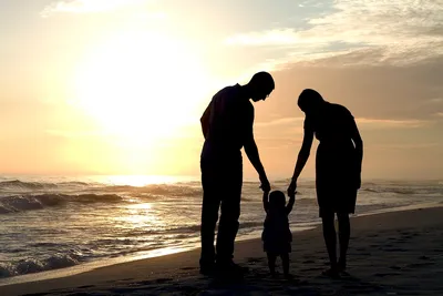 Happy Family On Beach Vacation Looking at Ocean Stock Photo by  ©Christin_Lola 61598681