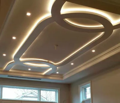 Монтаж гипсокартонных конструкций - Наиболее популярен дизайн потолка из # гипсокартона со скрытой подсветкой. Свет в них равномерно распределен,  рассеивается и отражается от потолка. Таким образом, создается впечатление  парящей в воздухе конструкции.