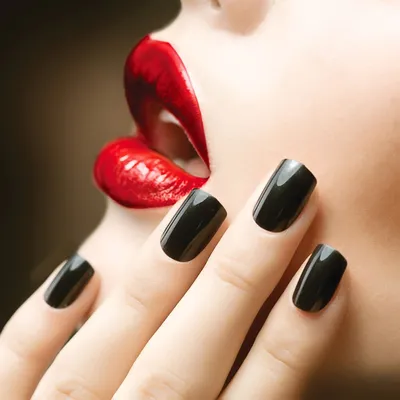 beautiful black-and-yellow manicure with shellac varnish in the form of a  sign of radioactive danger. hands of the girl on a black shiny background  Stock Photo - Alamy