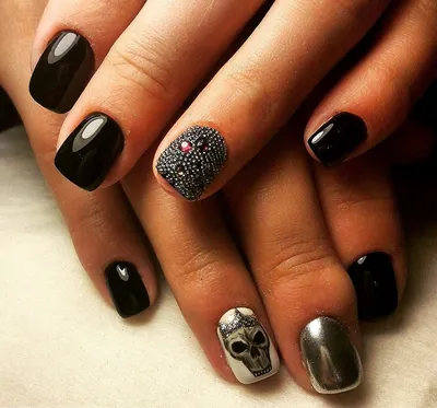 beautiful black-and-yellow manicure with shellac varnish in the form of a  sign of radioactive danger. hands of the girl on a black shiny background  Stock Photo - Alamy