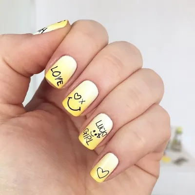 Black and white manicure with abstract flame design and marshmallow emoji.  Very long nails on women's